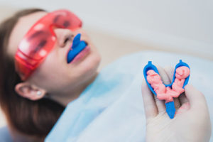 woman laying down with fluoride treatments tx working to prevent cavities