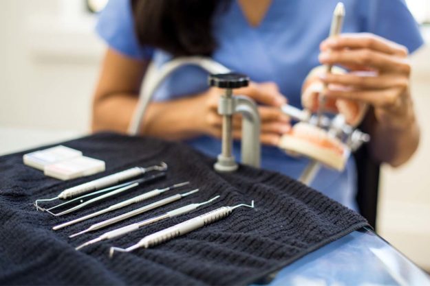 options-in-dental-services dentist practicing with tools for dental services