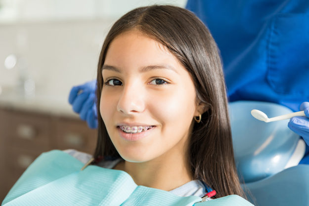 child getting braces to prevent teeth shifting