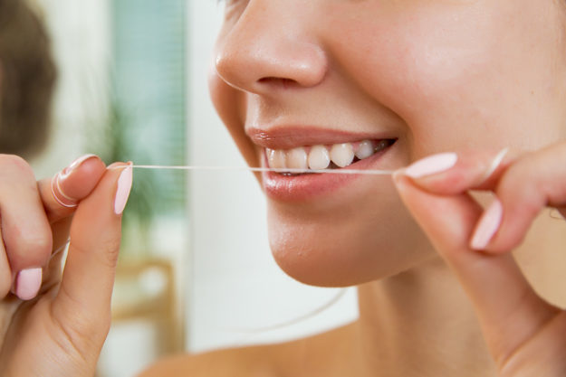 woman gaining the Benefits of Flossing Daily