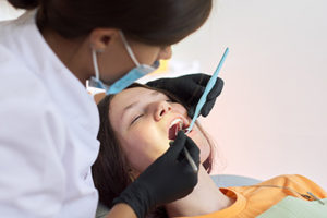 woman during general dentistry services with the Houston Sedation Dentist