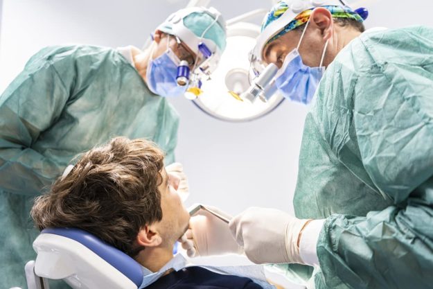 oral surgery (1) young man receiving oral surgery procedure