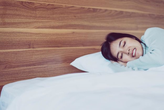 teeth grinding woman having trouble sleeping from teeth grinding