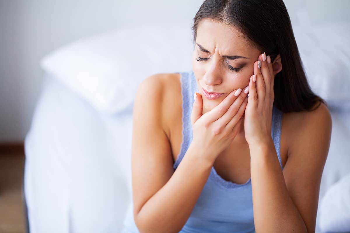 tooth cavity woman holding her jaw from tooth cavity pain