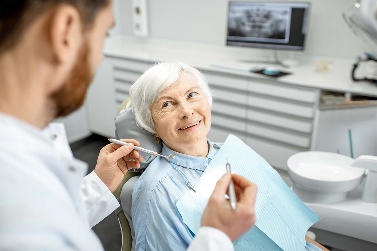going-to-the-dentist older woman getting dental exam