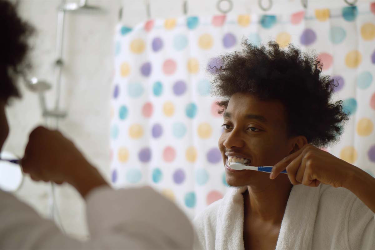 teeth-cleaning (1) woman brushing her teeth after teeth cleaning