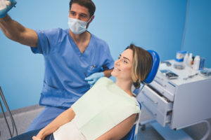 doctor prepares a patient for a root canal