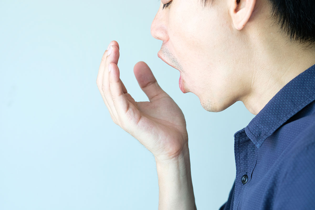 breath young man checks on his breath