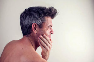 man suffering from teeth grinding