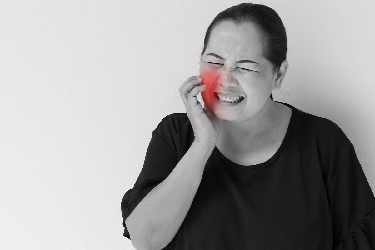 woman struggling with tooth decay